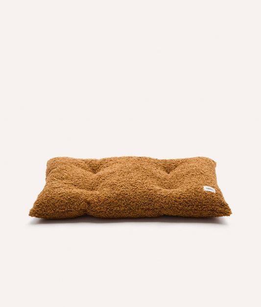Brown fluffy pillow on a white background
