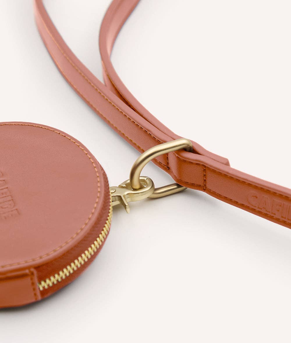 Brown leather coin purse with gold zipper on a white background