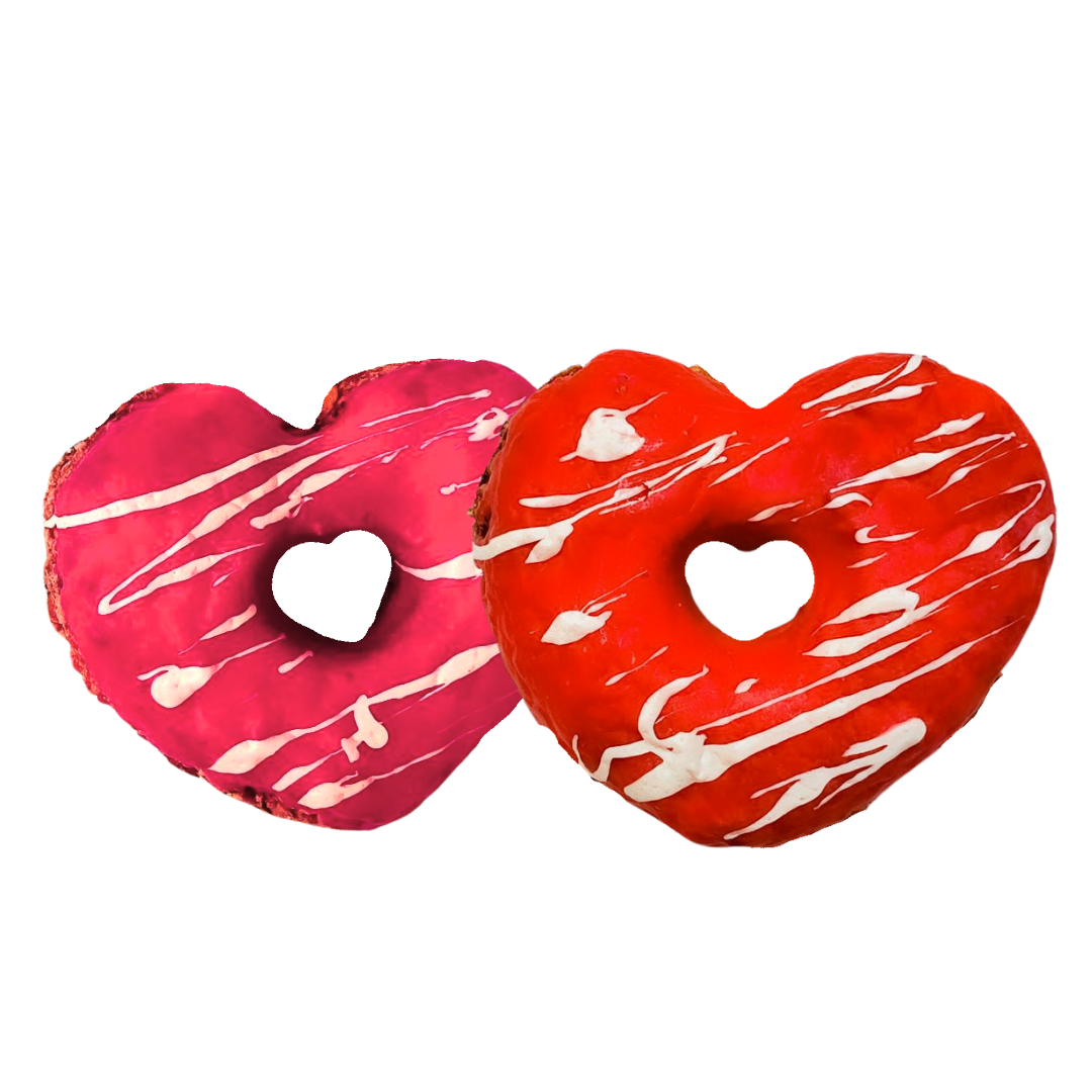 Two heart-shaped donuts with white drizzle on a white background