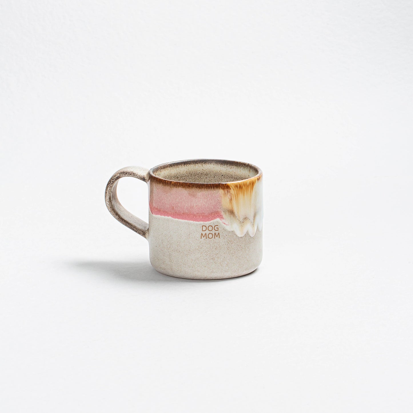 Ceramic mug with a dog illustration and 'Dog Mom' text on a white background