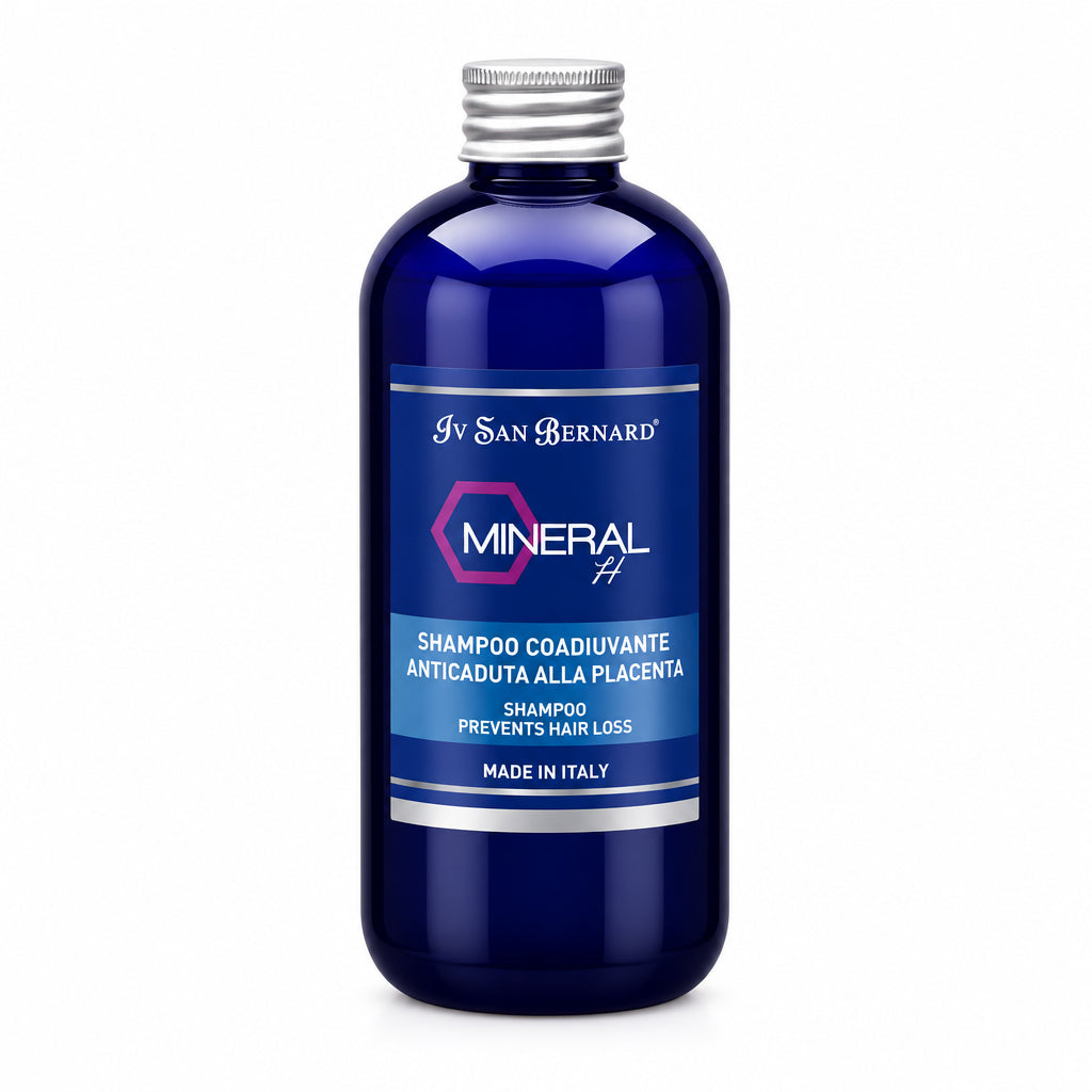 A dark blue bottle of Iv San Bernard Mineral HA shampoo for dogs with a silver cap and a blue label, shown on a plain white background.