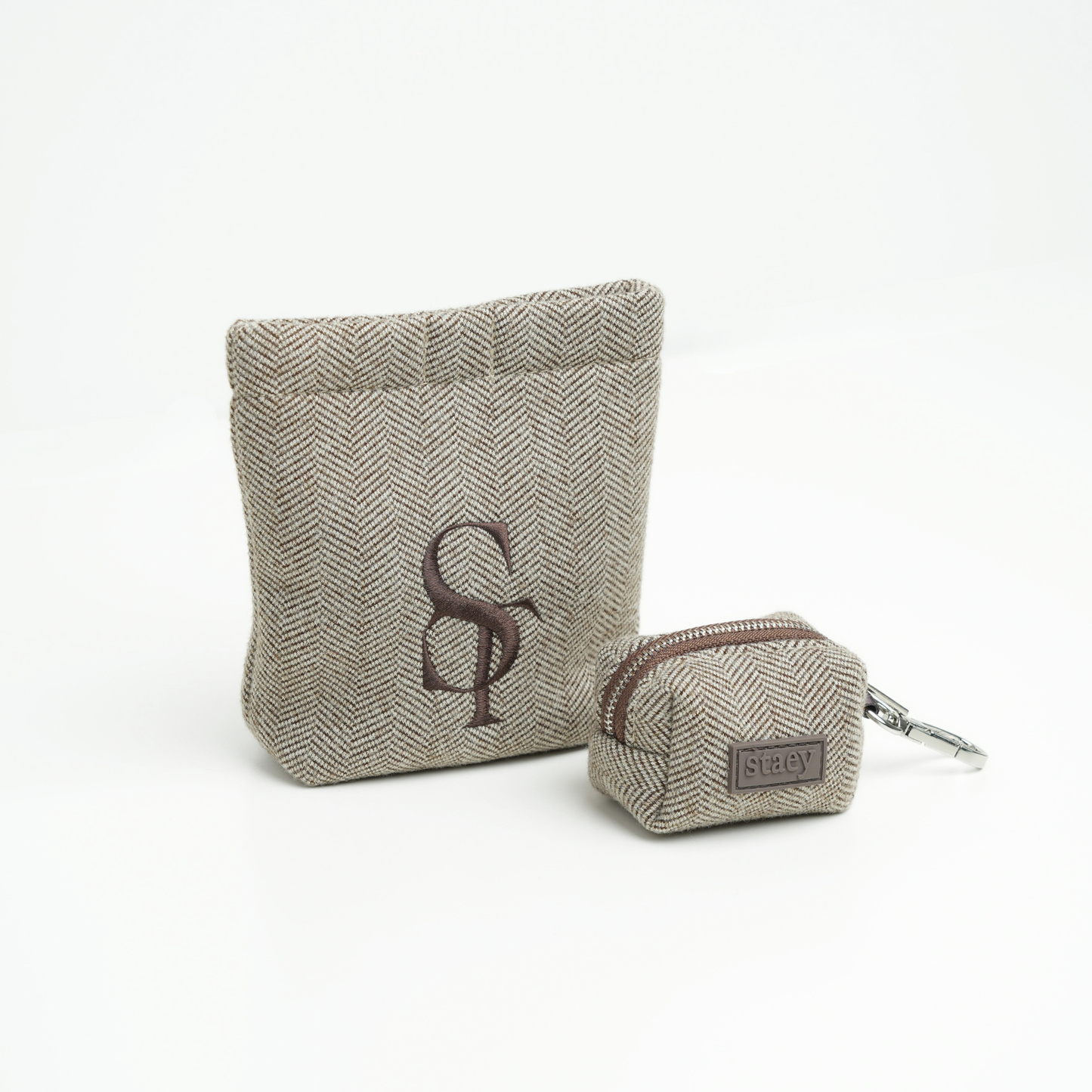 Two fabric pouches with a logo on a white background