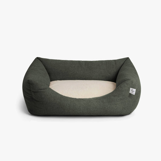 Dark gray pet bed with white interior on a light gray background