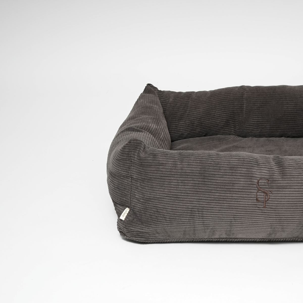 Gray corduroy pet bed on a white background
