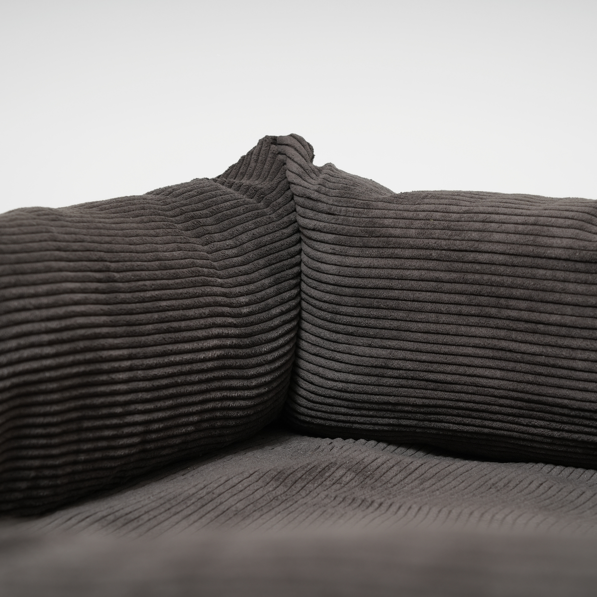 Gray corduroy fabric on a plain background