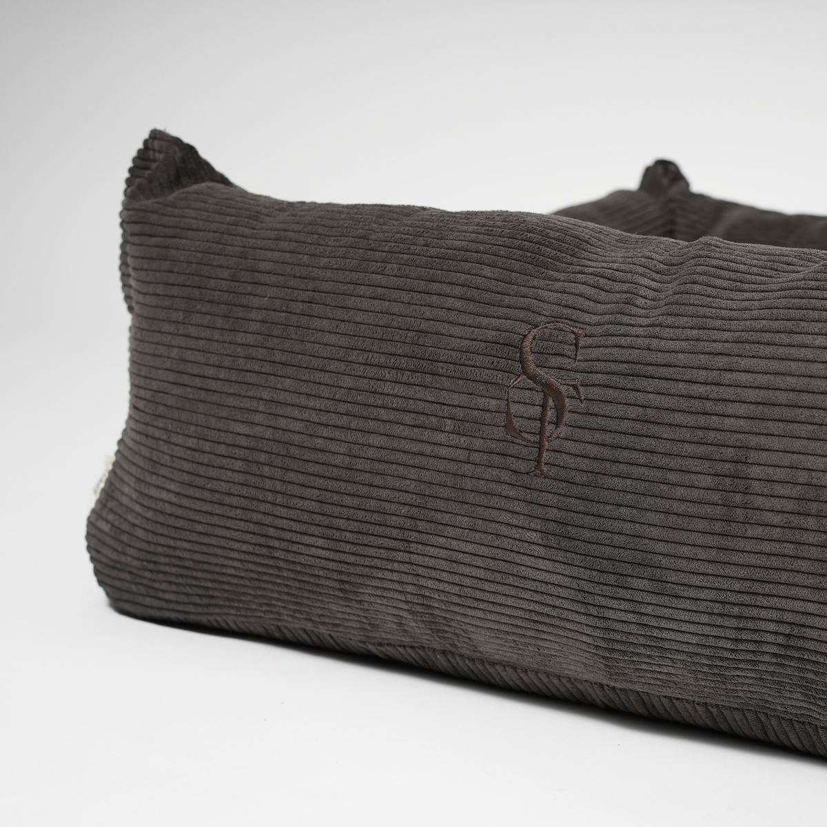 Gray textured pillow with a logo on a white background