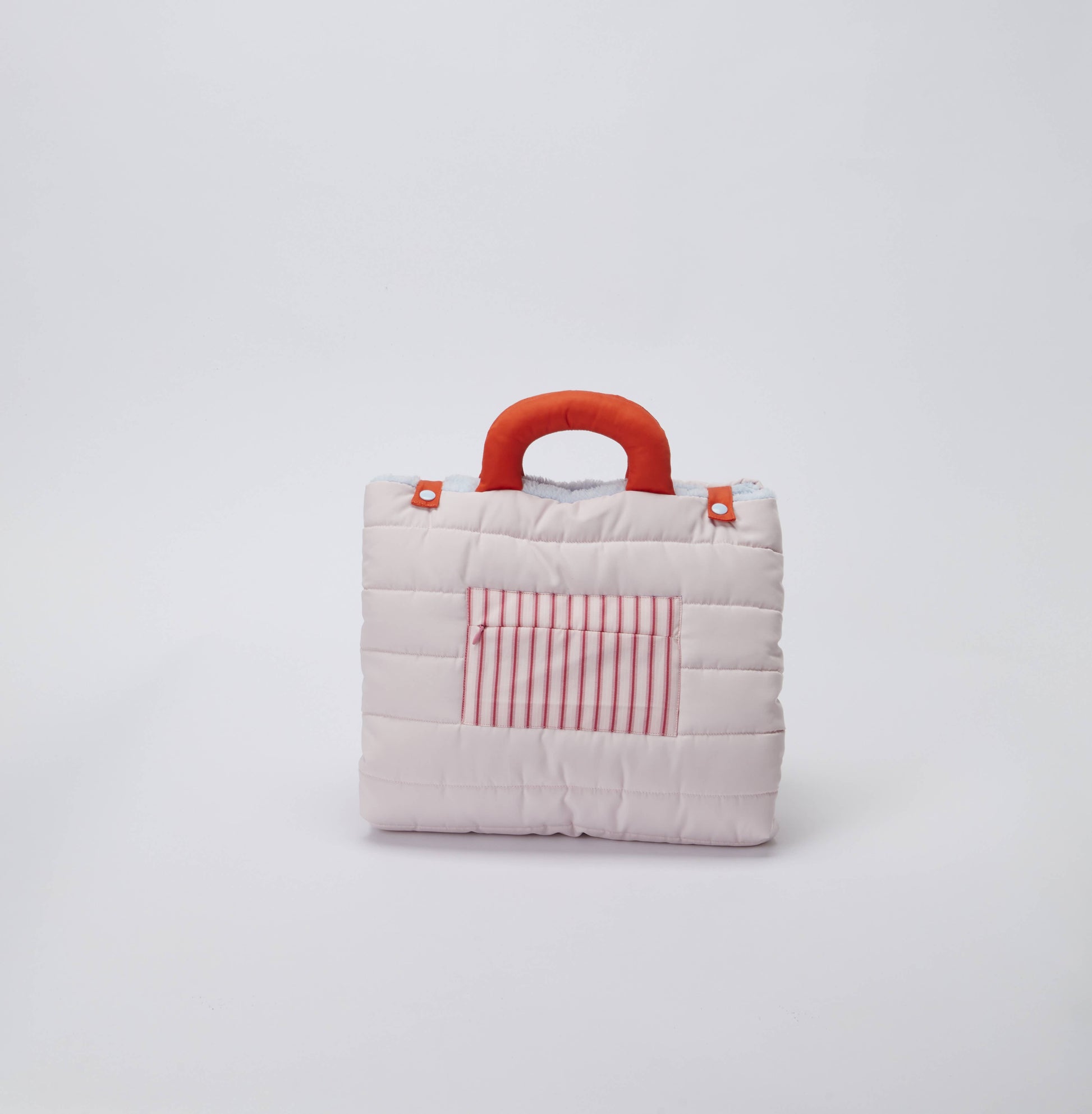 Small quilted dog bag with a red handle and striped pocket on a light gray background