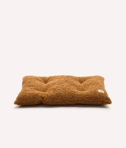 Brown fluffy pillow on a white background