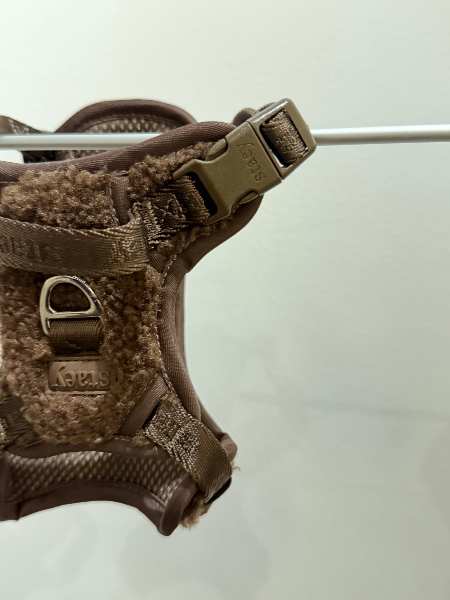 Brown tactical dog harness on a white background