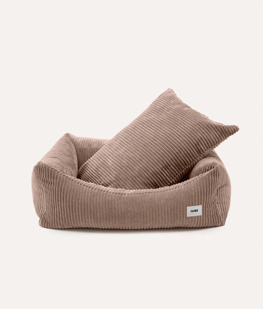 Brown pet bed with a pillow on a white background