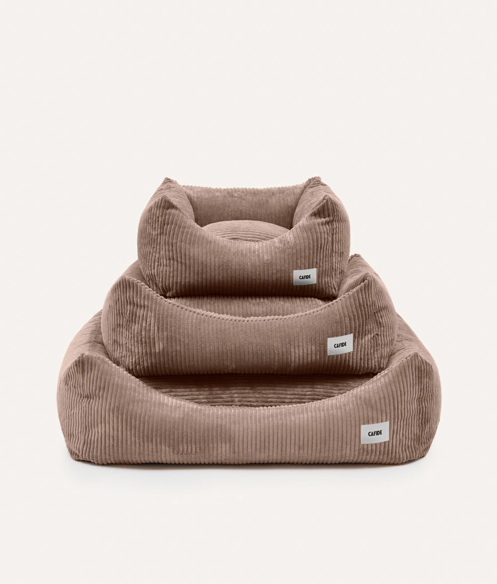 Two brown corduroy pet beds with visible labels on a white background