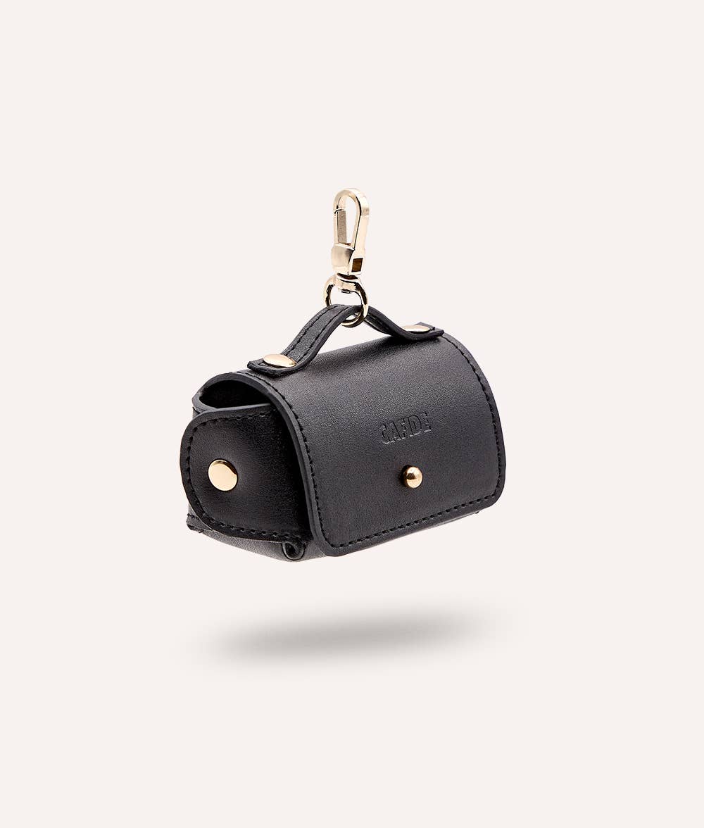 Black sustainable innovative leather dog waste bag with gold accents on a white background