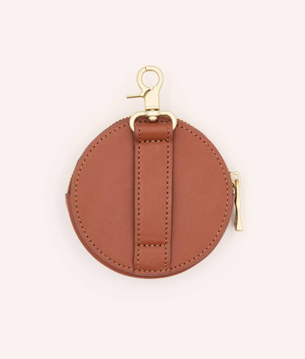 Brown round coin purse with gold clasp on a white background