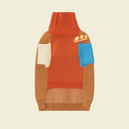 Dog sweater with colorful patchwork design on a beige background, featuring the brand 'LIKA'.