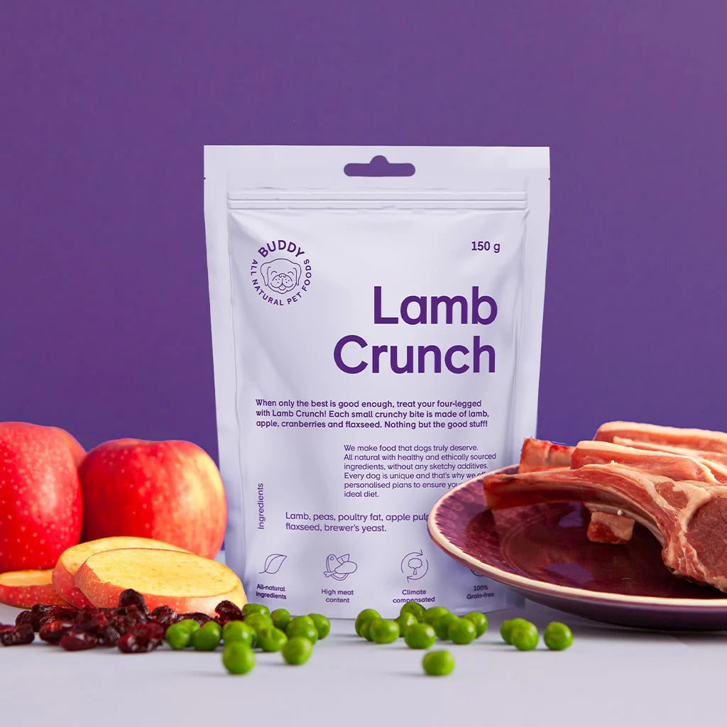 Buddy & Friends Lamb Crunch packaging with lamb bones, apples, and peas on a purple background