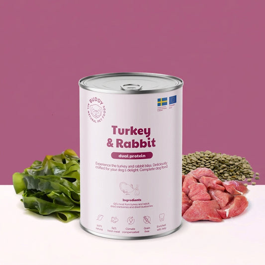 Can of turkey and rabbit dog food with ingredients on a pink background