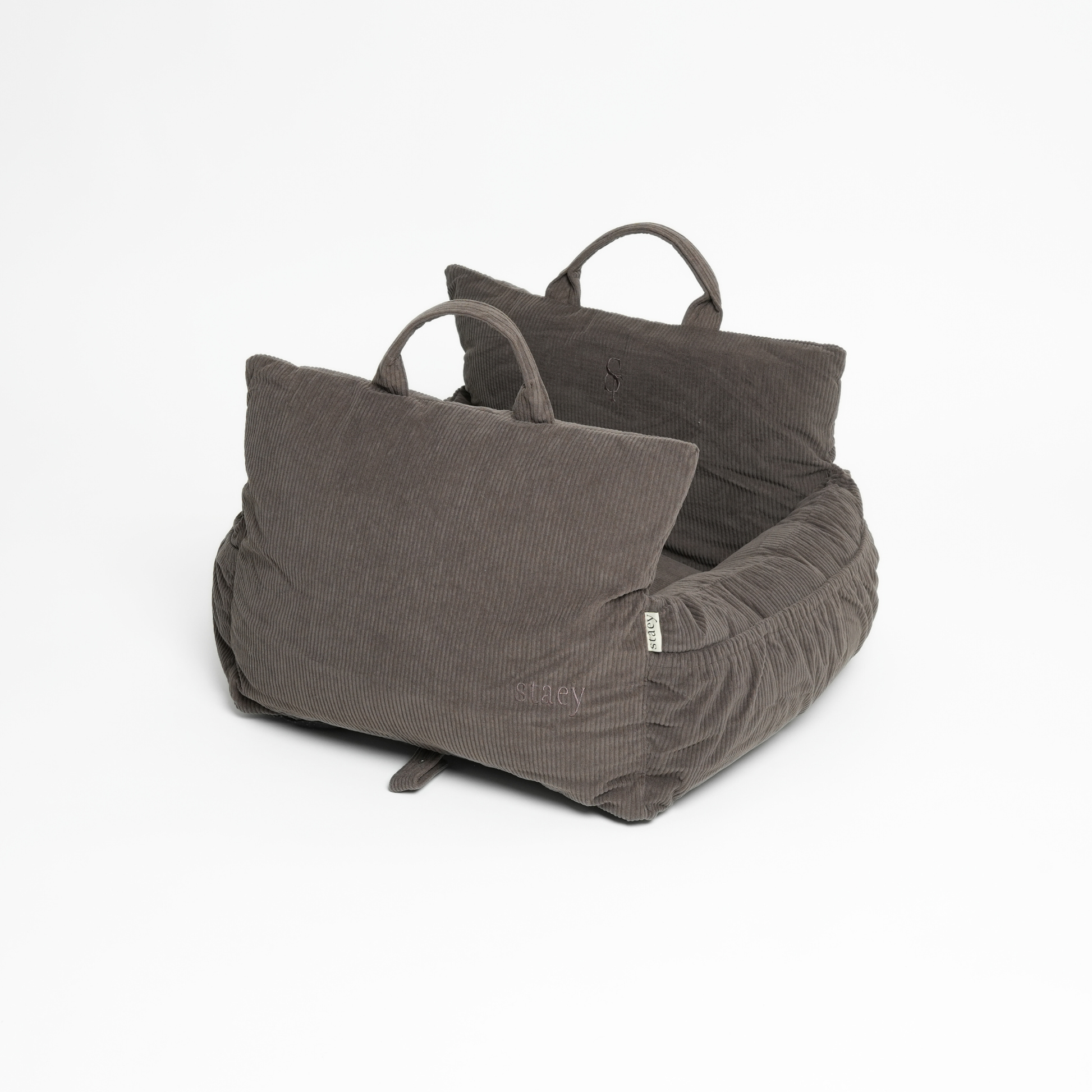 Gray pet bed with two pillows on a white background