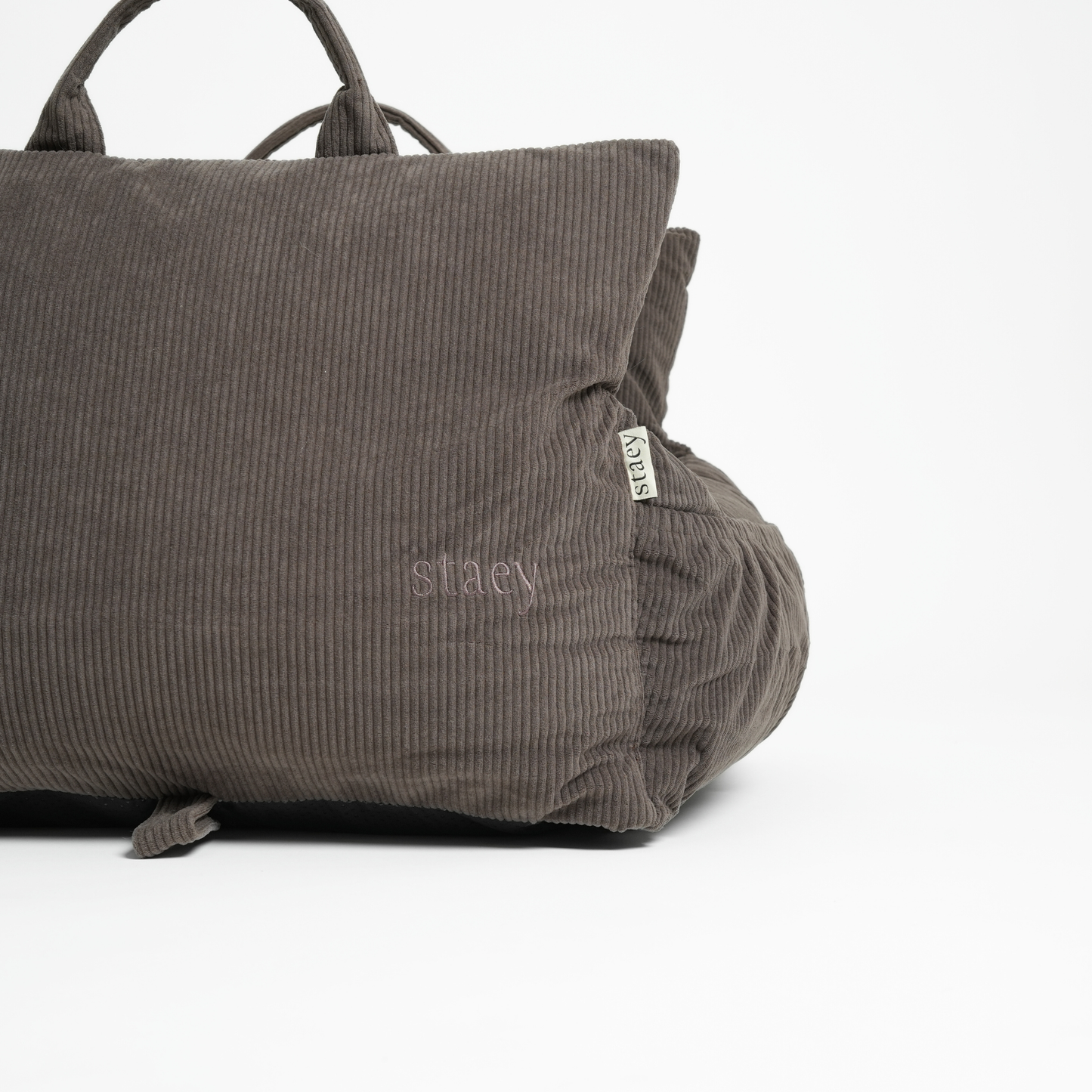 Gray textured bag with 'stelvi' branding on a white background
