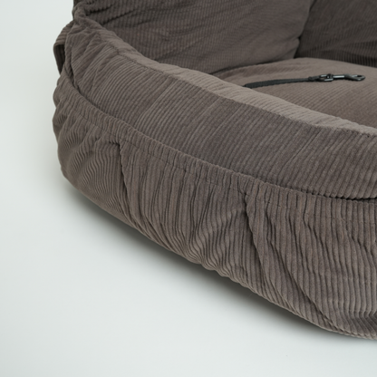 Brown textured pet bed on a light gray background