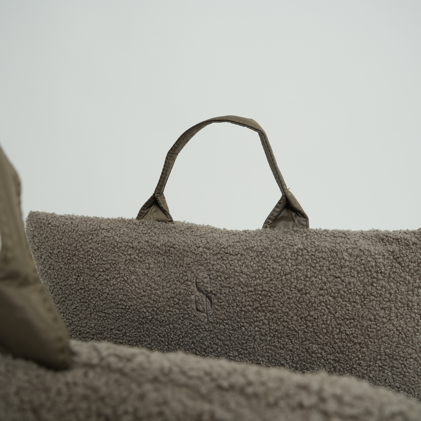 Textured bag with a handle on a neutral background