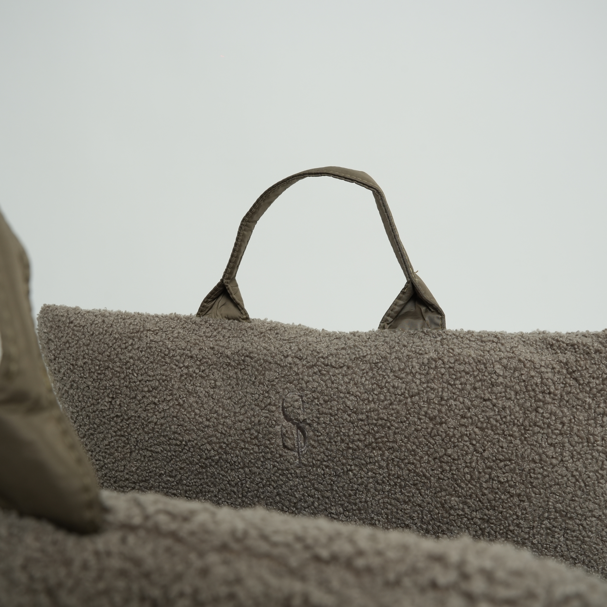 Textured bag with a handle on a neutral background