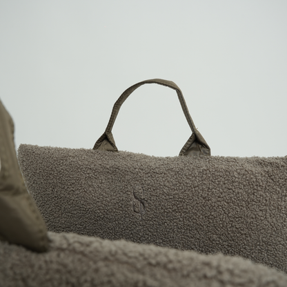 Textured bag with a handle on a neutral background