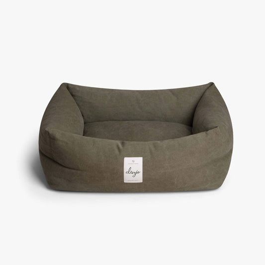 Brown pet bed with a visible brand label on a white background