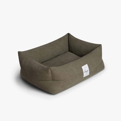 Brown pet bed with a visible brand label on a white background
