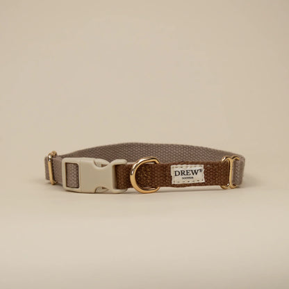 Brown dog collar with gold buckle on a beige background