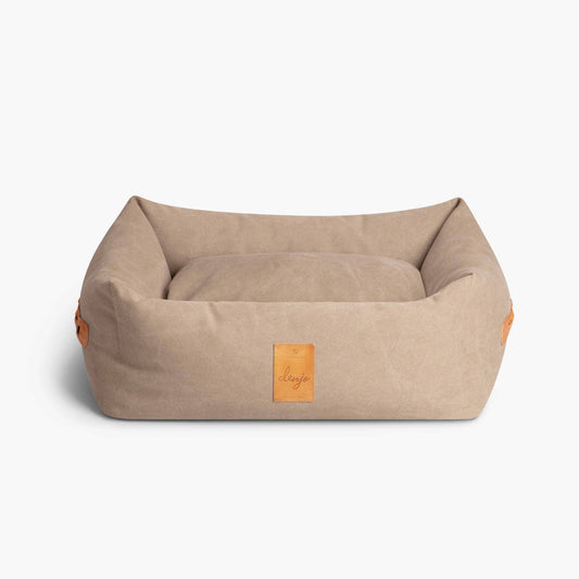 Beige pet bed with brown accents on a white background