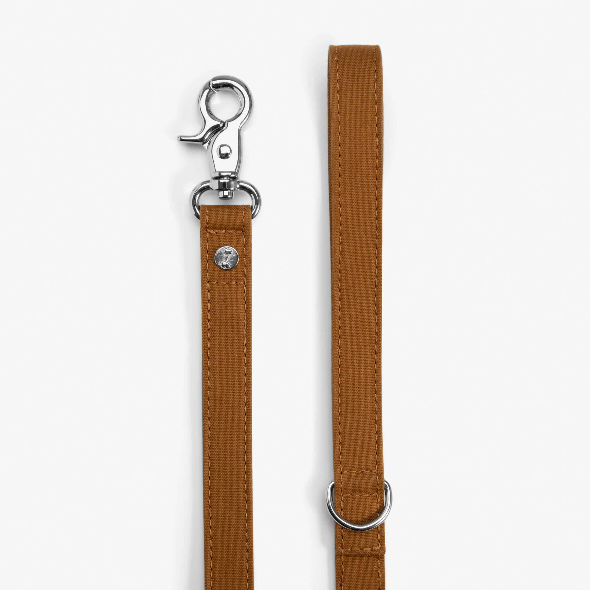 Brown leather dog leash with metal clip on a white background