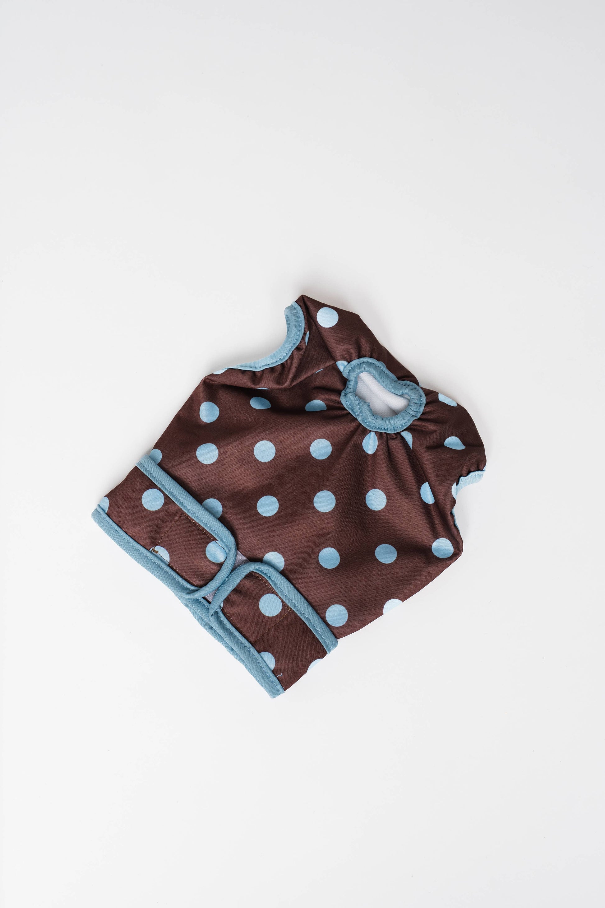 Brown swimsuit with blue polka dots on a white background