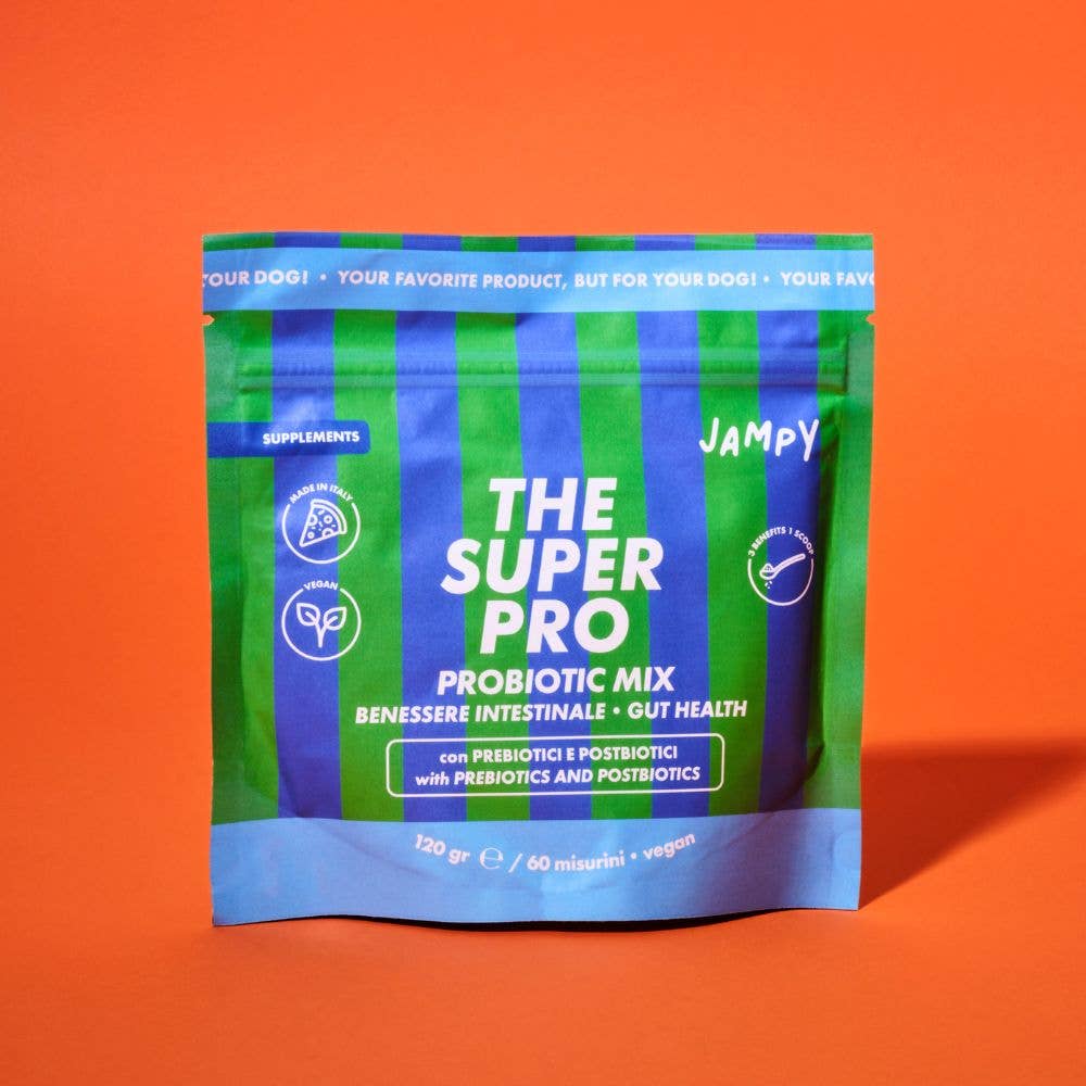 A stand-up pouch of 'The Super Pro' probiotic mix for dogs, featuring green and blue vertical stripes with white text, set against a solid orange background.
