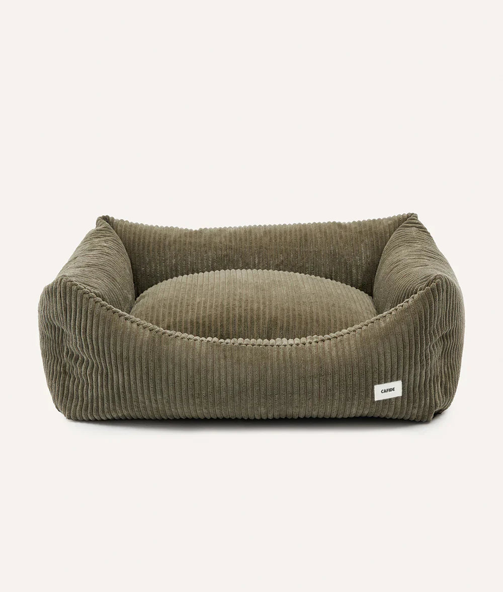 Green corduroy pet bed on a white background