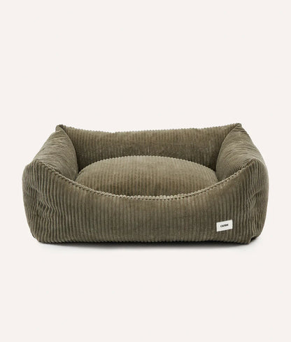 Green corduroy pet bed on a white background