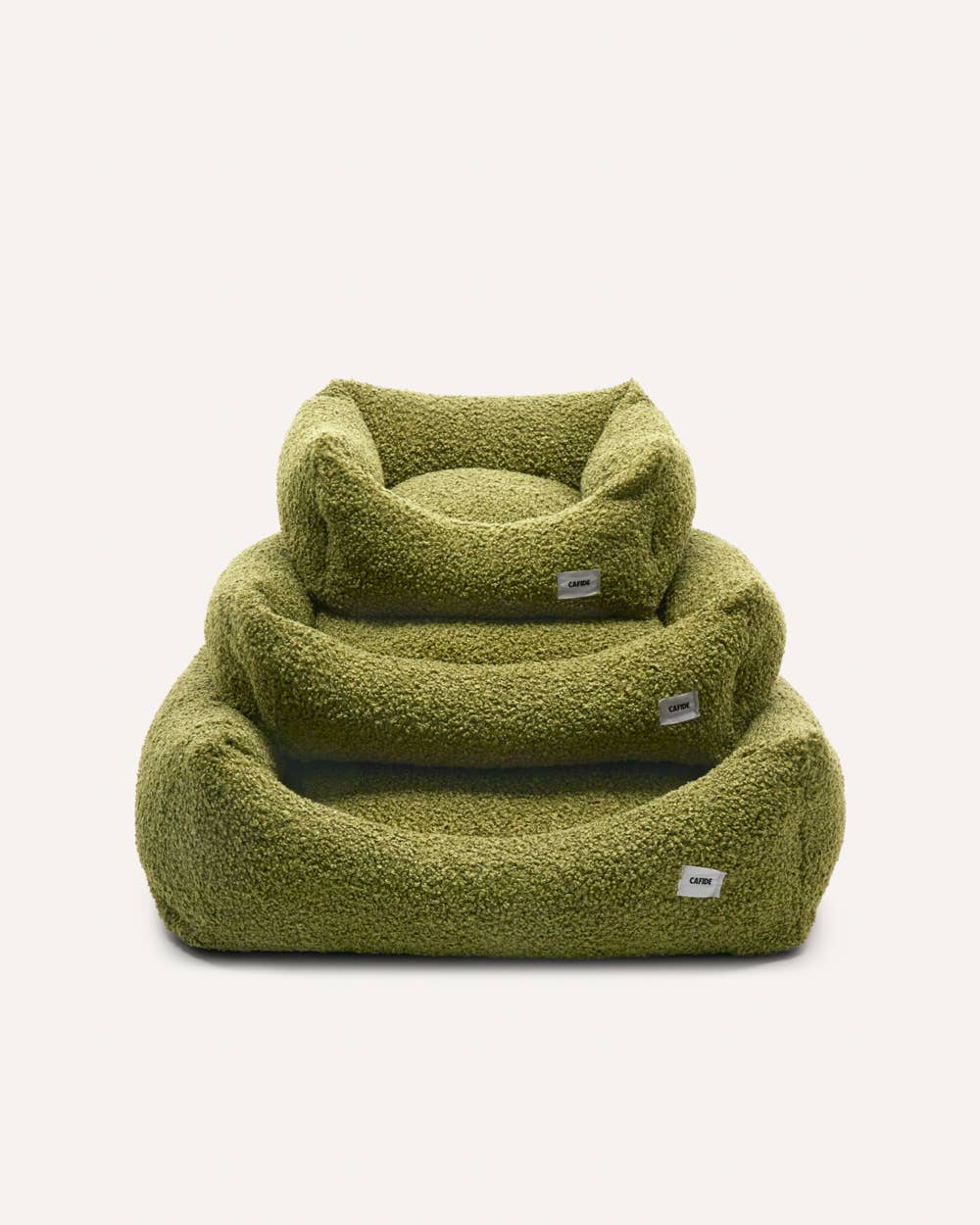 Green pet bed with a soft texture on a white background