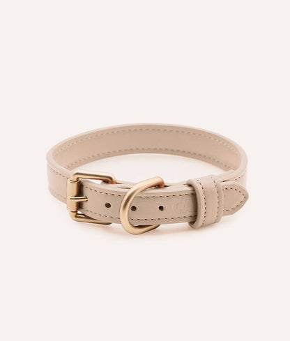 Beige leather dog collar with a gold buckle on a white background
