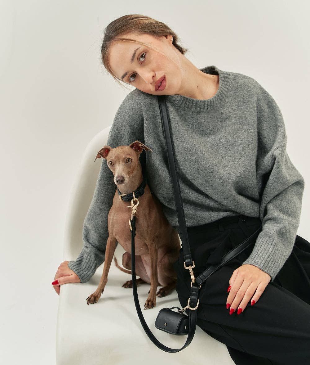Woman in a gray sweater with a dog on a white background