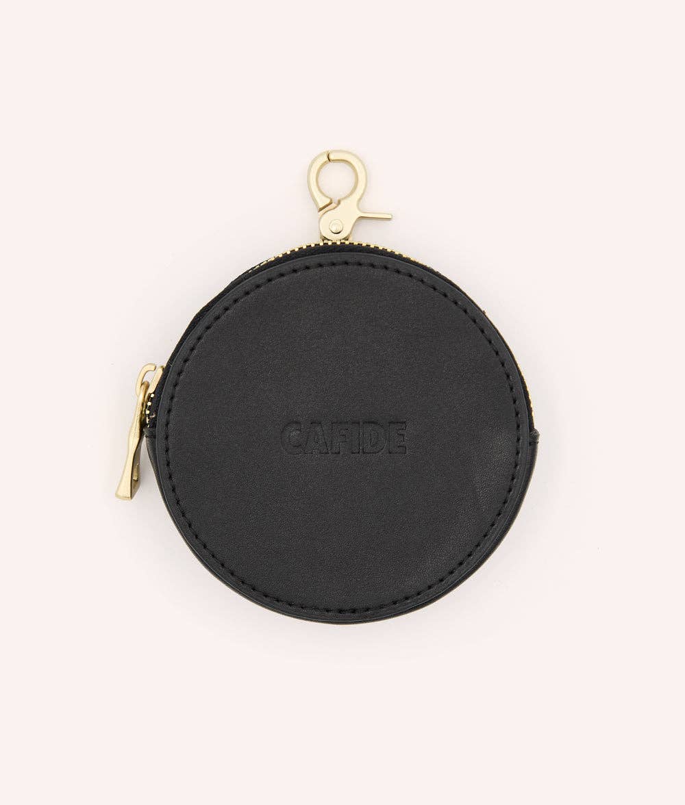 Black round dog treats purse with gold zipper on a white background