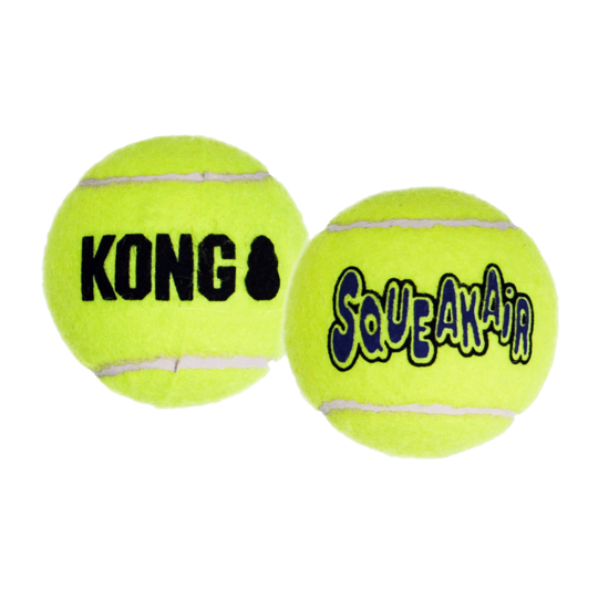 Two yellow KONG SqueakAir tennis balls on a white background