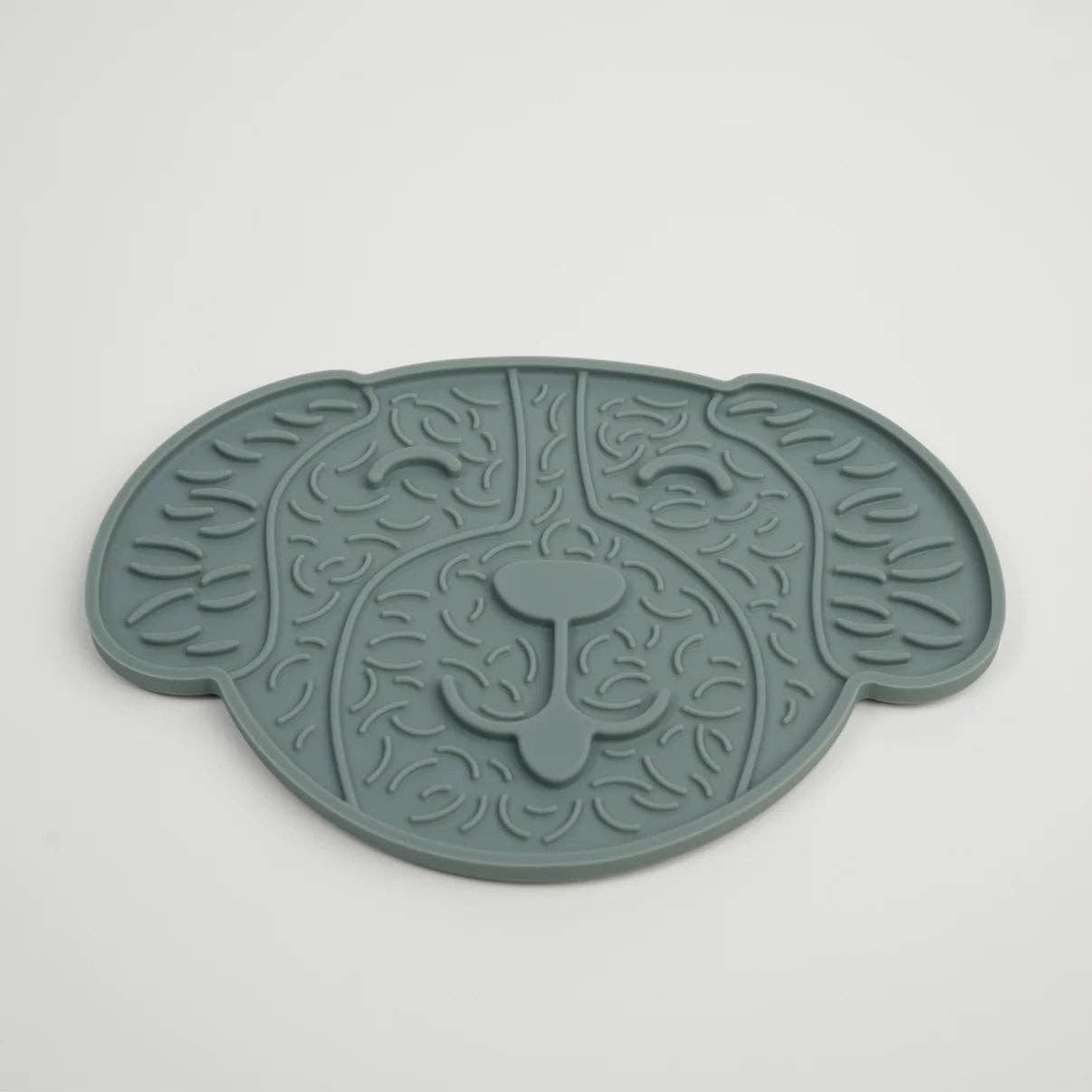 Green pet mat with leaf pattern on a white background