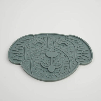 Green pet mat with leaf pattern on a white background