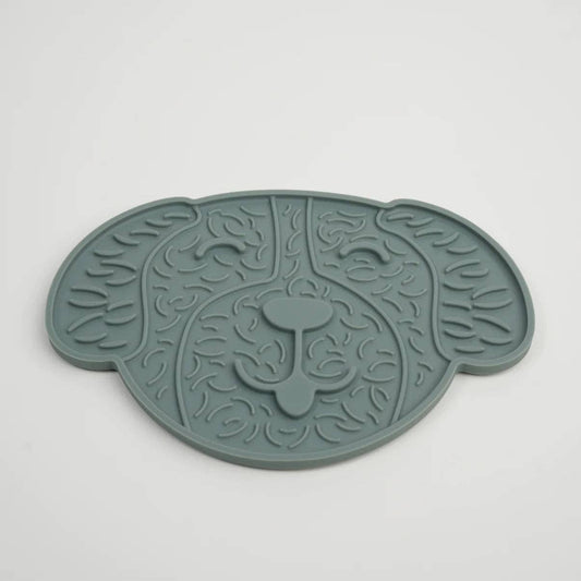 Green pet mat with leaf pattern on a white background