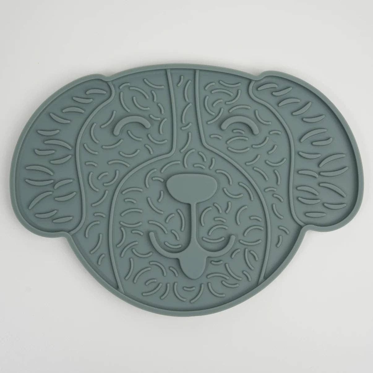 Green silicone mat with a lion design on a white background
