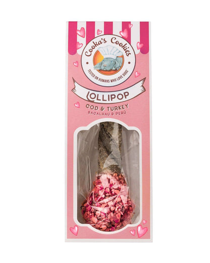 Pink lollipop-shaped dog treat packaging with visible text and a window showing the treat inside.