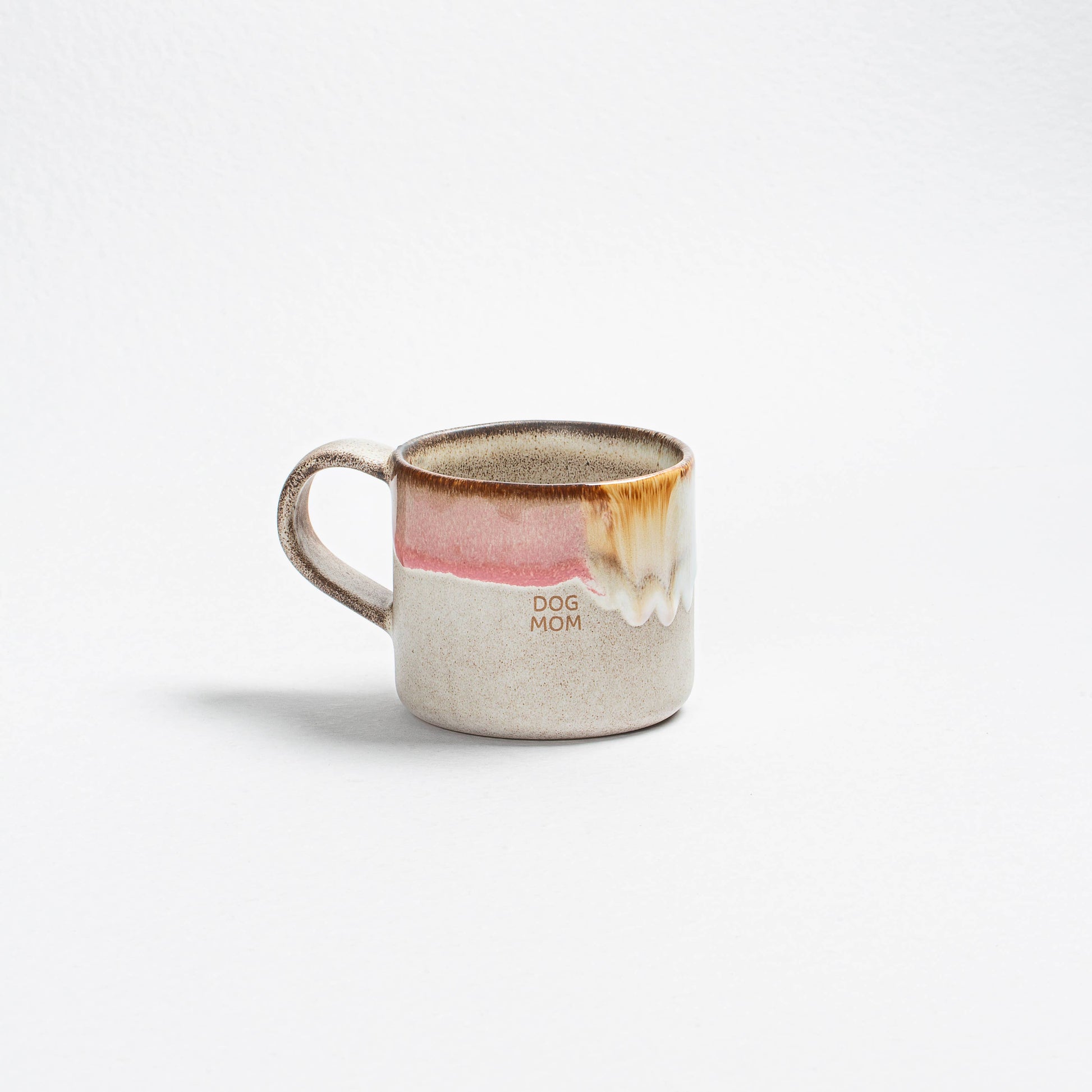 Ceramic mug with a dog illustration and 'Dog Mom' text on a white background