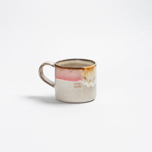 Ceramic mug with a dog illustration and 'Dog Mom' text on a white background