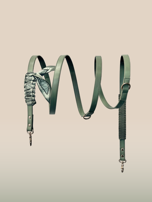 Green leather strap with decorative elements on a beige background