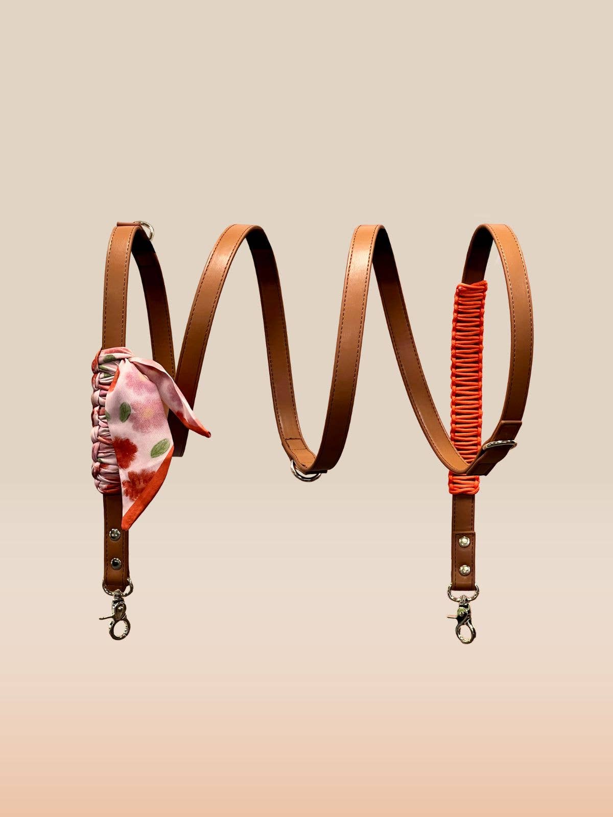 Two leather straps with floral and red accents on a beige background