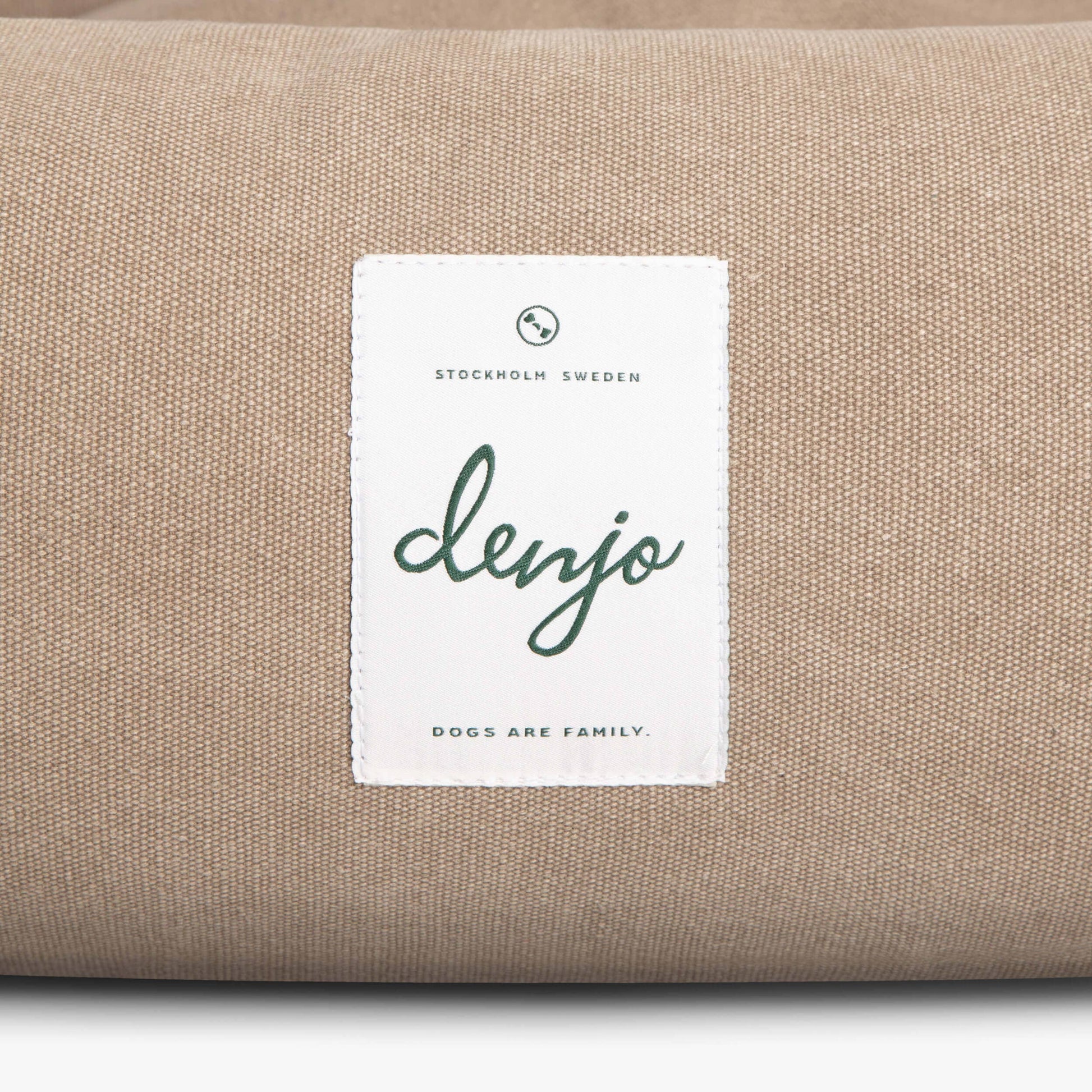 Beige fabric with a 'denjo' label on a white background